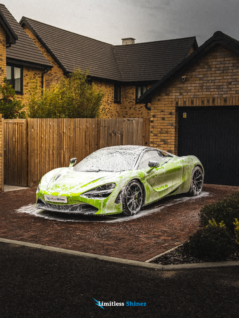 McLaren covered in snow foam on a driveway